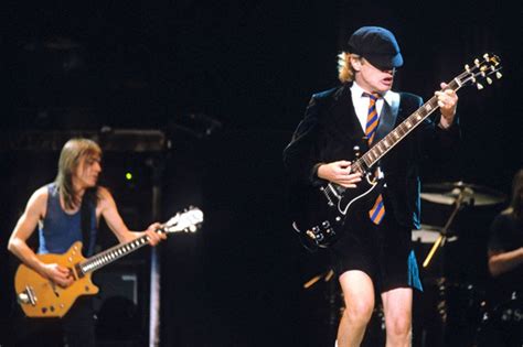 AC/DC's Angus Young on the Rhythm Guitar Playing of Malcolm Young | Acdc angus young, Angus ...