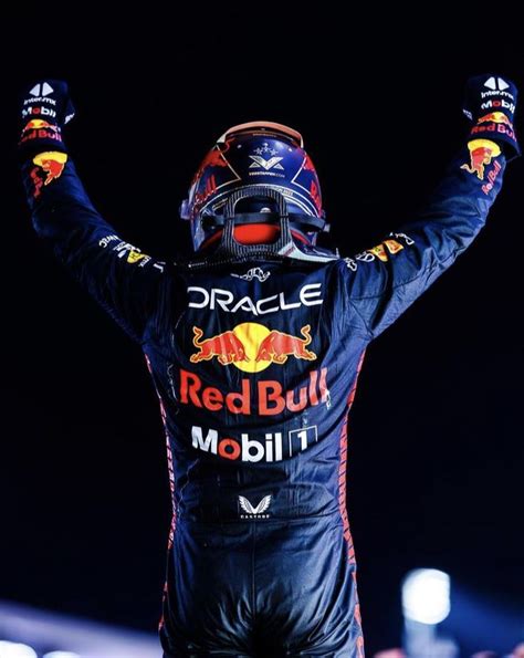 A Red Bull Driver Raising His Hands In The Air