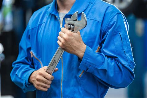 Mechanic Hand Holding Wrench Equipment Tool In Auto Repair Garage