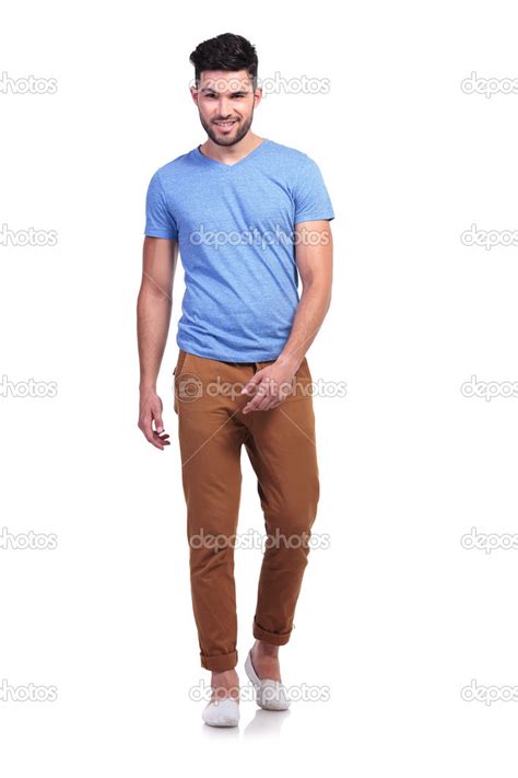 Casual Man Walking Towards The Camera And Smiles Stock Photo By