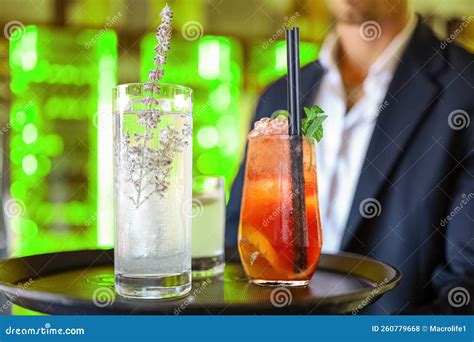 Waiter Carries Cocktails On Tray On Background Of Girl Outdoors Close