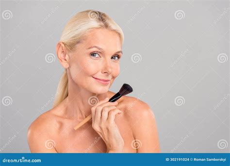 Photo Of Dreamy Positive Senior Lady Nude Shoulders Applying Visage