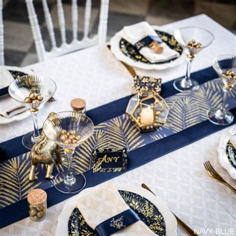 The Table Is Set With Blue And Gold Place Settings