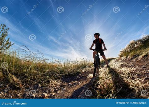 Young Cyclist Riding Mountain Bicyclist Against Beautiful Sunset In The