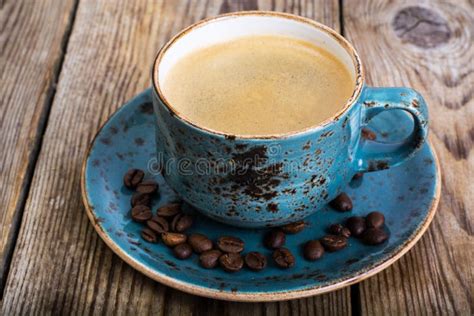 Espresso Coffee In Blue Cup On Vintage Wooden Background Stock Image