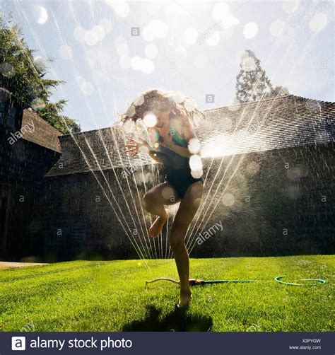 Girl Running Through Sprinkler Stock Photos And Girl Running Through