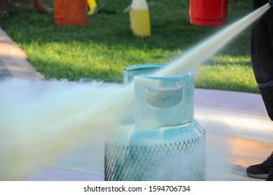 Man Using Fire Extinguisher Fighting Fire Stock Photo