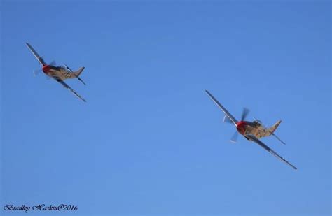 Two Small Airplanes Flying In The Blue Sky