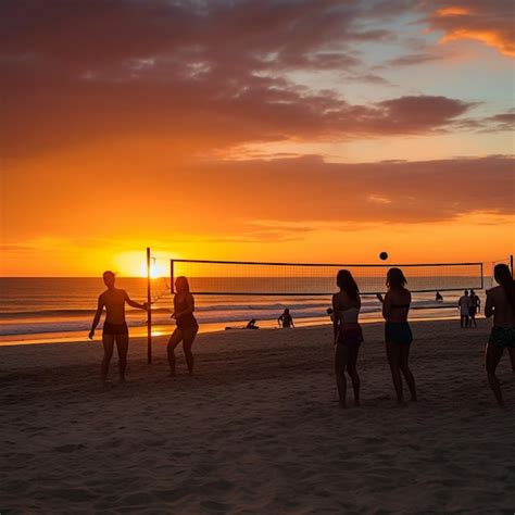 Premium Photo People Playing Volleyball On The Beach At Sunset With A