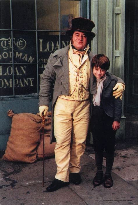 an old man and young boy dressed up in period clothing posing for a ...