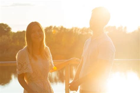 Premium Photo Couple Embracing While Standing By Lake