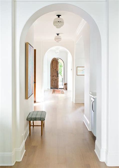 Arched Doorways With Light Brown Wooden Floors Transitional