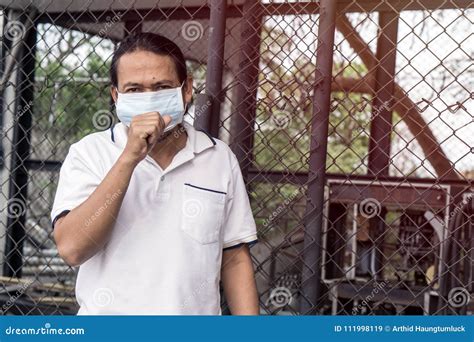 Asian Man Wear Face Mask Medical Protection In Wood Factory Stock