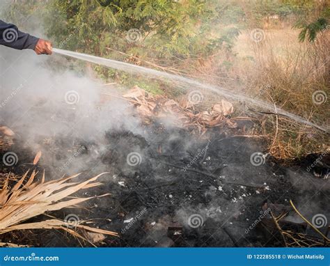 The Hand Who Extinguish Fire With Water Stock Photo Image Of Close