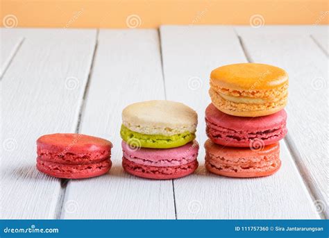 Different Types Color Of Macaroons On White Wooden Background Stock