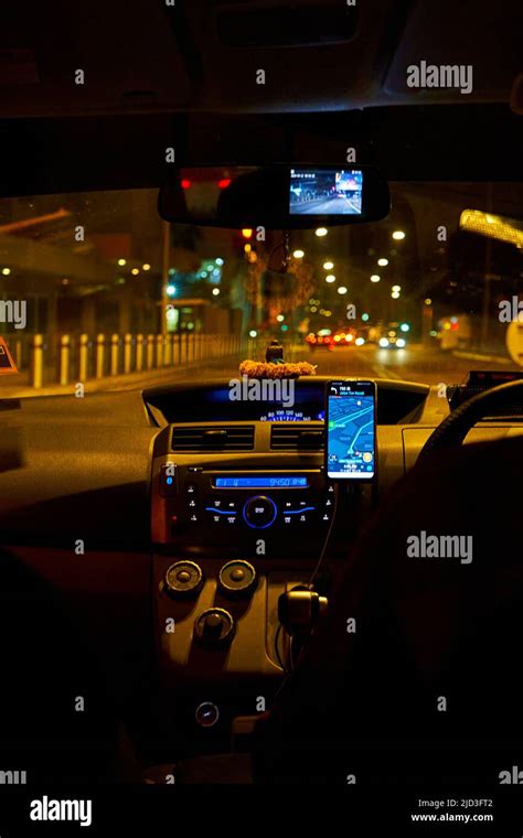 interior of a car driving night rainy city. blurred city lights. Kuala ...