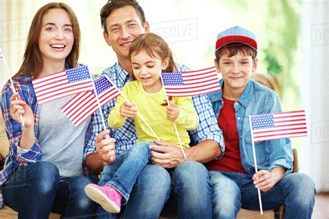 Happy family with flags of USA celebrating Independence Day - Stock ...