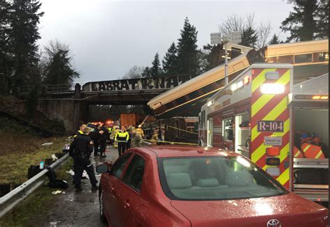 Amtrak Derailment Train Car Dangles Over Washington Interstate At
