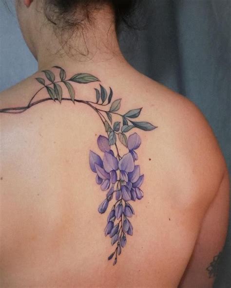 A Woman S Back With Purple Flowers On It