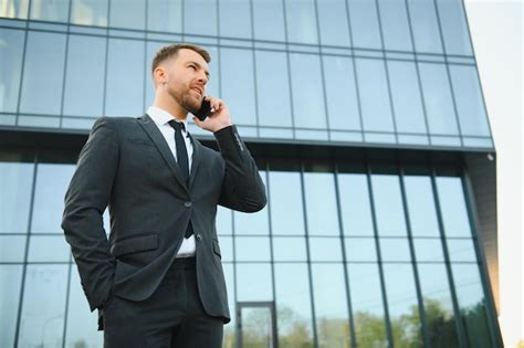 Premium Photo Businessman Using Smartphone In Covered Walkway