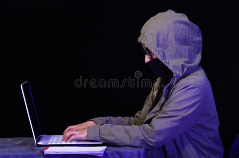 Portrait of a Beautiful and Smart Girl Hacker with Laptop on Dark Background Using Glasses and ...