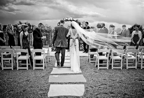 Gorgeous Photo Of The Bride And Groom Walking Down The Aisle During The