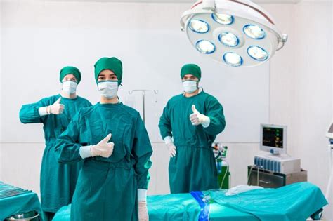 Premium Photo Surgery Doctors Raise Their Thumbs Surgery Doctors