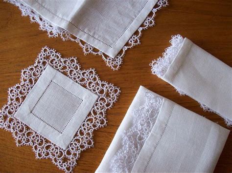 Four Pieces Of White Linen With Lace On Them