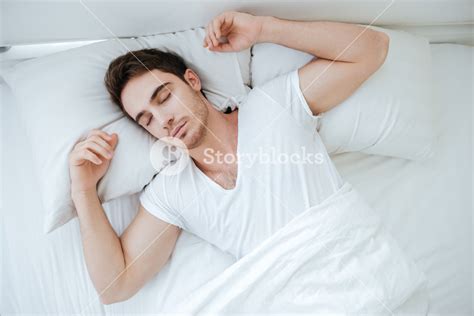 Top View Of Young Man Peacefully Sleeping In Bed Royalty Free Stock