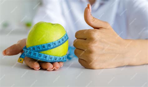 Premium Photo Apple With Measuring Tape On Hand Weight Loss Counting