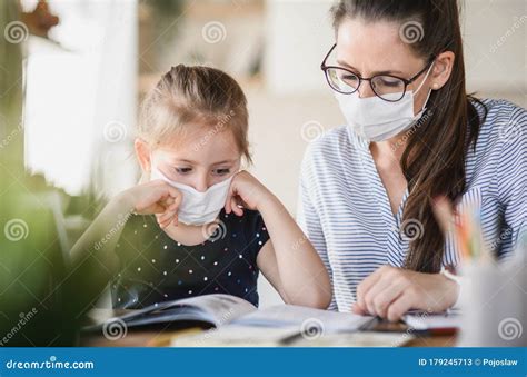 Mother And Daughter Learning Indoors At Home Corona Virus And