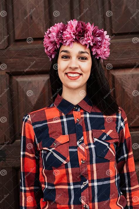 Pretty Stylish Girl With Pink Flower Crown In Front Of A Wooden Stock