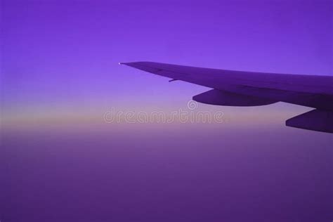 Sunrise Sky With Airplane Wing Seen From Plane Window During Flight In