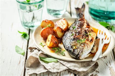 Grilled Sea Bream With Potatoes Herbs And Tomatoes Stock Image Image