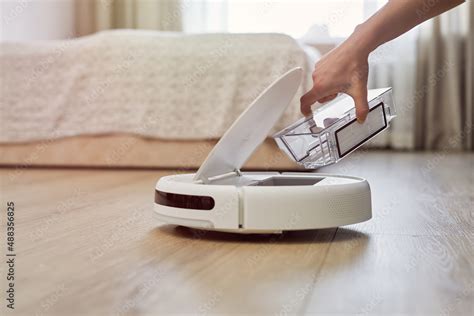 Preparation of filter cleaning of the vacuum robot cleaner from dirt. Installing a dust ...