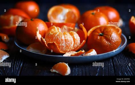 Juicy Ripe Tangerines On A Plate Peeling A Tangerine Skins Of Citrus