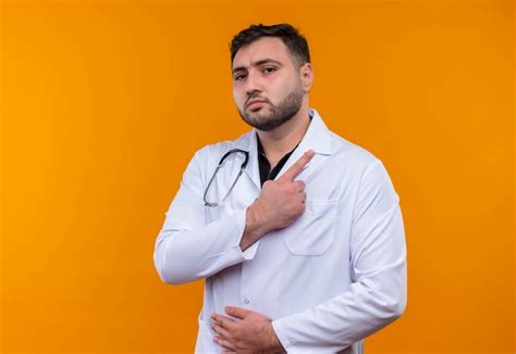 Free Photo Young Bearded Male Doctor Wearing White Coat With