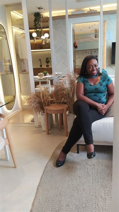 A Woman Sitting On Top Of A White Couch