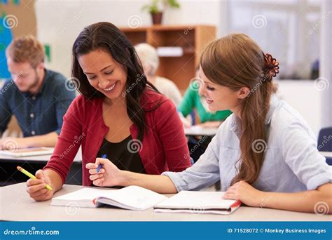 Teacher And Student Work Together At Adult Education Class Stock Photo