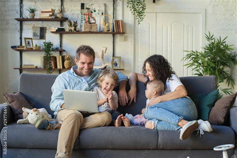 Young beautiful happy family relaxing at home Stock Photo | Adobe Stock