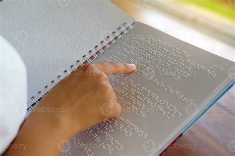 visually impaired person reads   fingers  book written