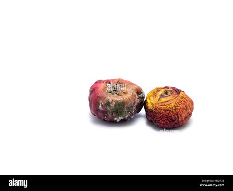 Two rotten fruits isolated on white background Stock Photo - Alamy