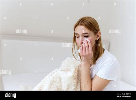 Unhappy Depressed Caucasian Woman Crying And Wiping Away Her Tears With A Paper Napkin