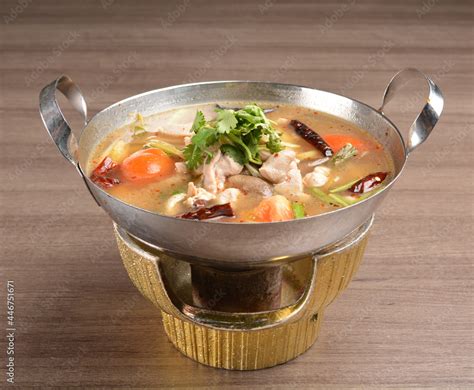 Thai Clear Tom Yum Spicy Chilli Hot Soup With Seafood Meat And Vegetables In Hot Pot In Wood
