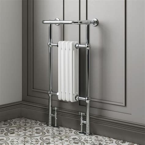 A White Towel Rack In A Bathroom With Tile Flooring And Gray Walls