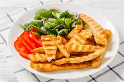 Premium Photo Grilled Chicken Strips On A Plate With Vegetables