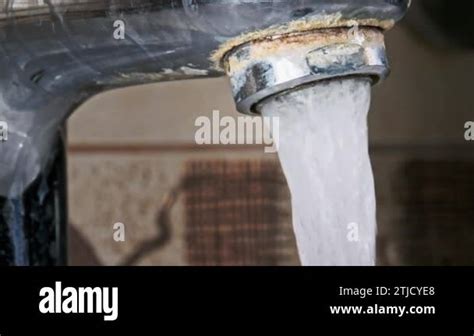 Faucet With Running Water In Slow Motion Macro Shot A Jet Of Water