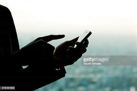 Hand Silhouette Holding Phone Photos and Premium High Res Pictures ...