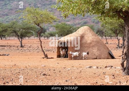 Traditional African Round Clay House With Thatched Roof In Village