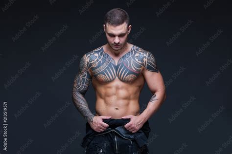 The Man With A Muscular Naked Torso With Tattoos On The Dark Background ABS Stock Photo Adobe